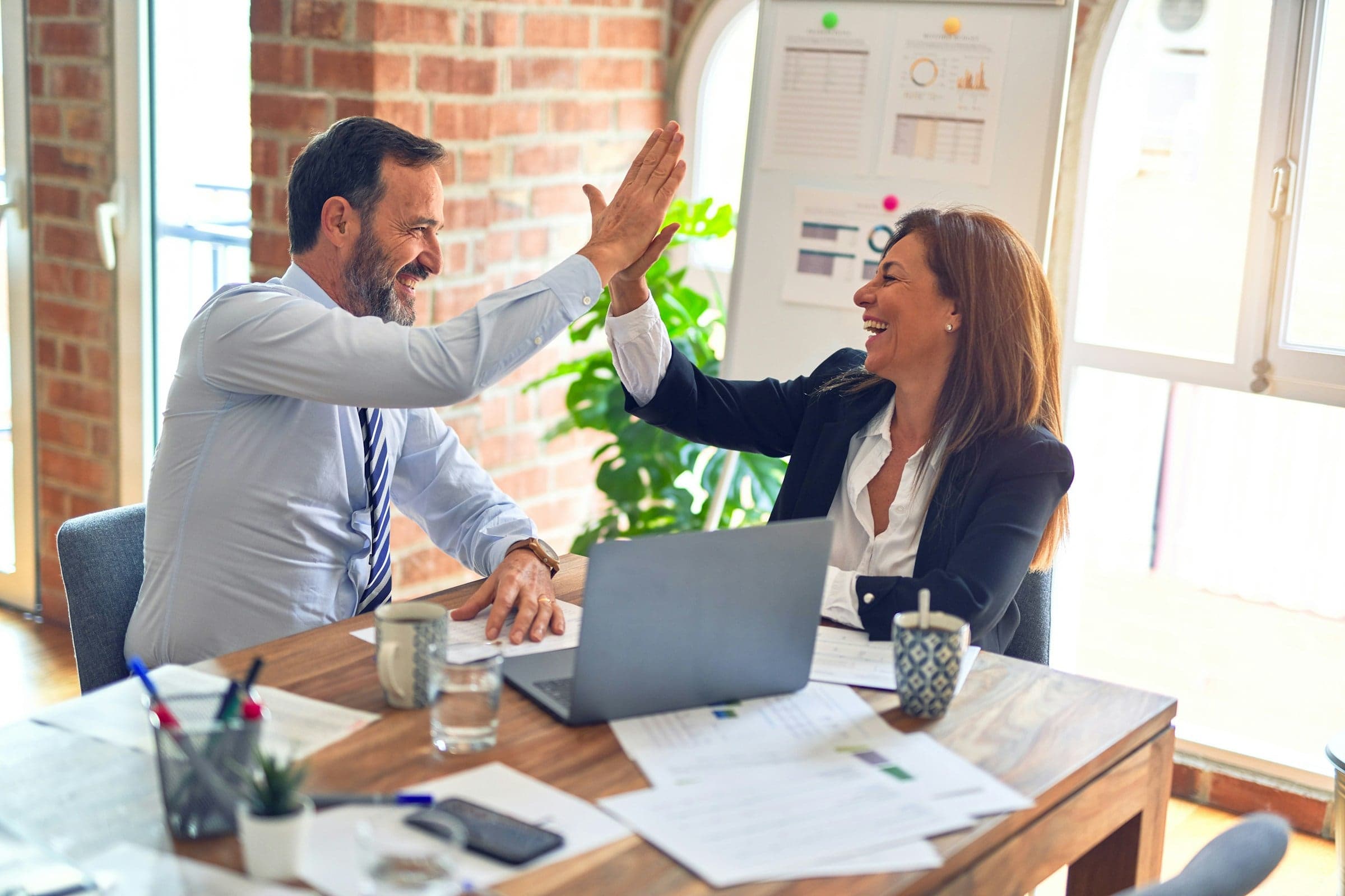 Two Xelovix teammates celebrating at work