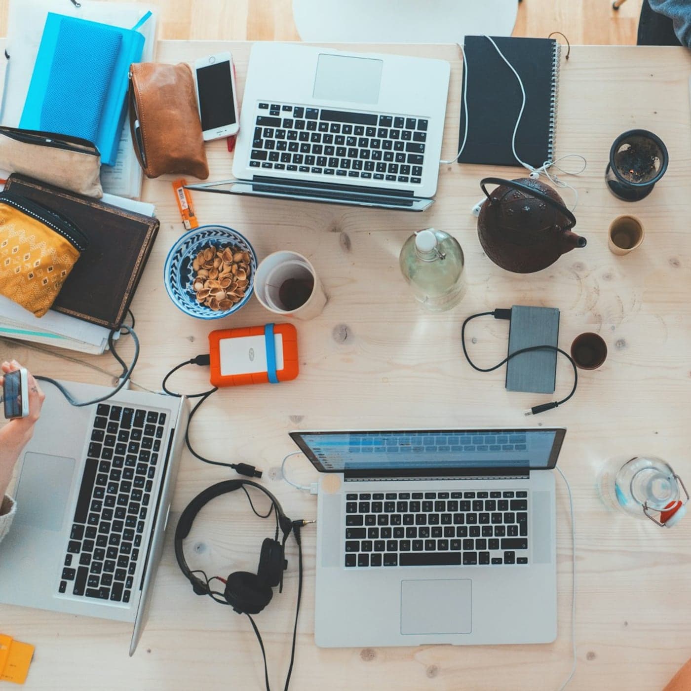 Team workspace seen from above with laptops and tools